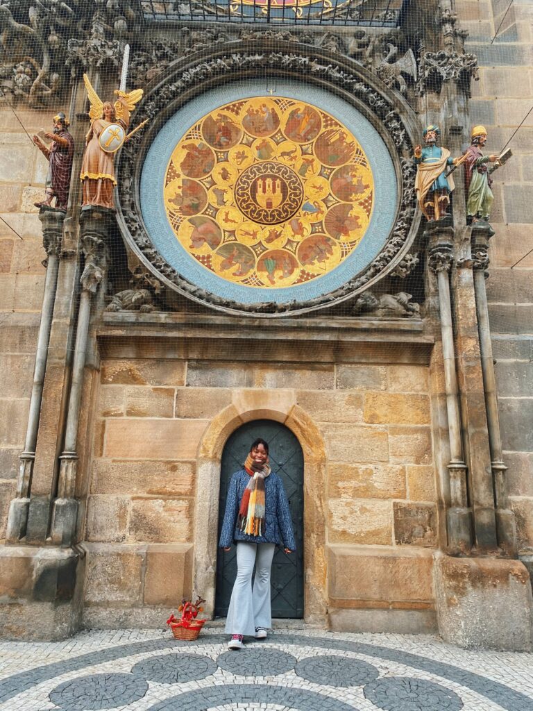Abigail standing in front of the Astronomical Clock in Old Town Square, Prague
