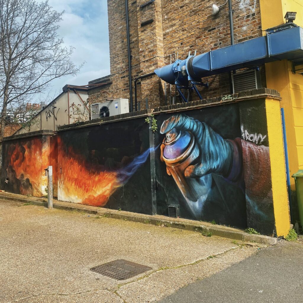 Mural on Hawley Road of a can shooting flames