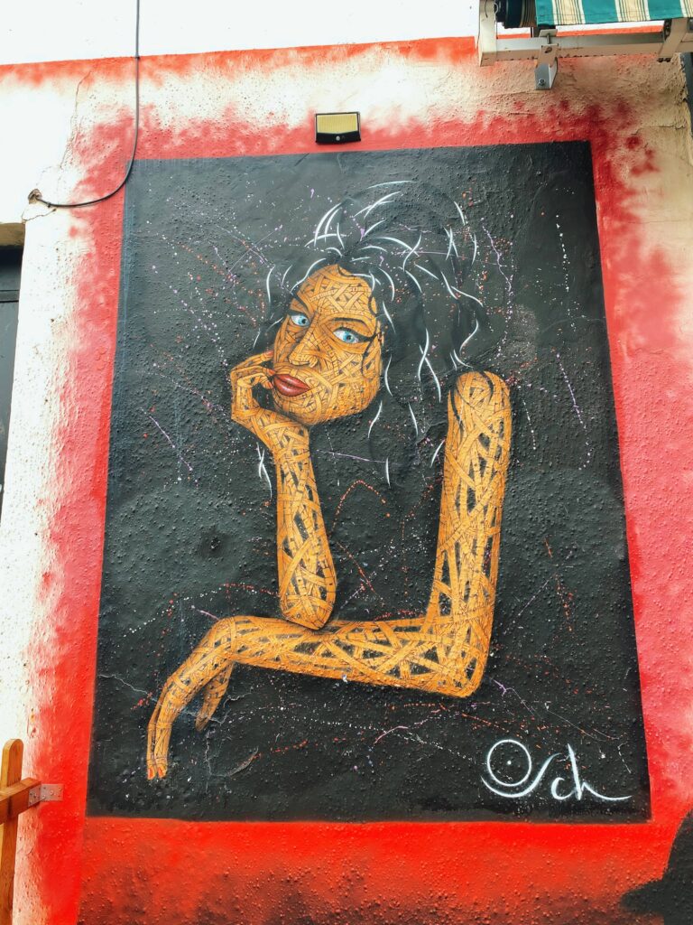 Mural on Hawley Street in Camden of Amy Winehouse resting hear chin on her hand