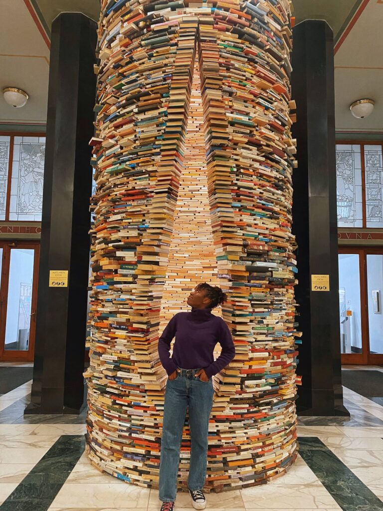 Abigail standing in front of the Infinity Book tunnel looking up