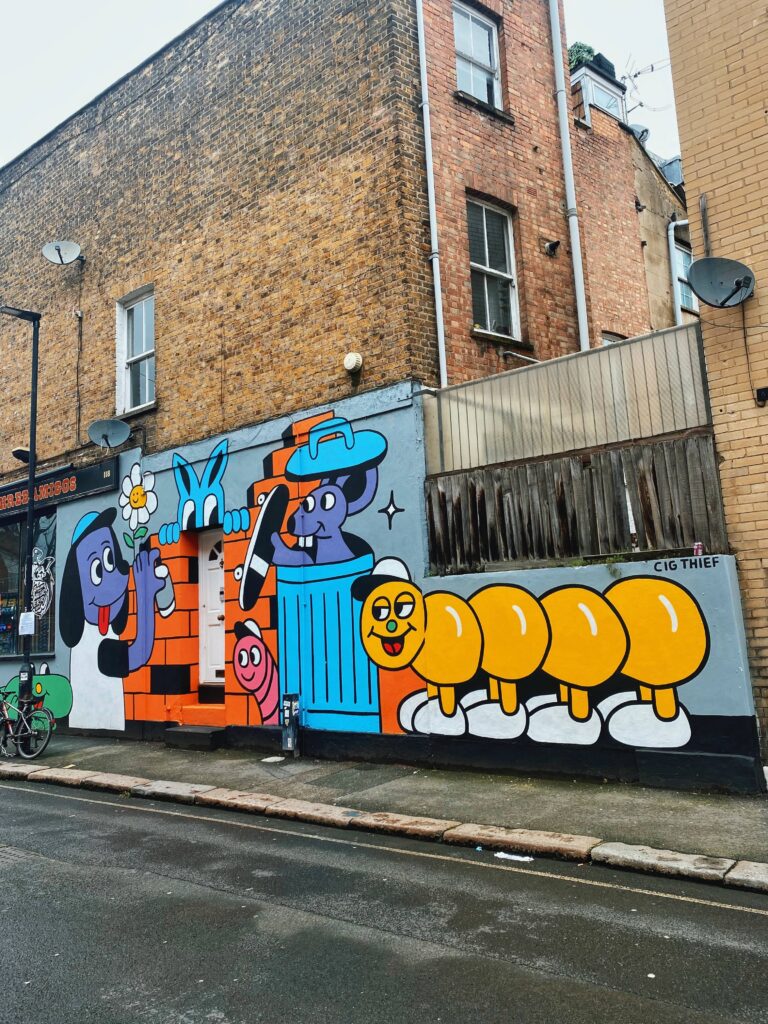 Mural of a dog, worm, caterpillar and rat on Rousden Street in Camden