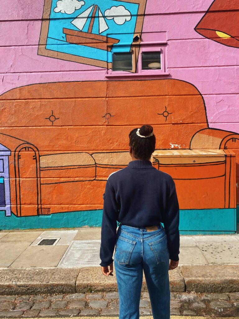 Abigail facing the Simpsons mural wall in Camden Town