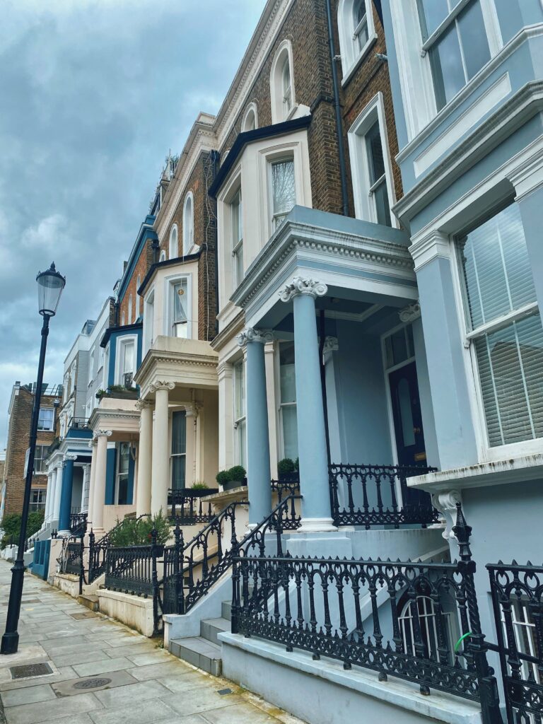 A row of colorful houses with colourful porch roofs and Ionic columns at Powis Gardens, Notting Hill