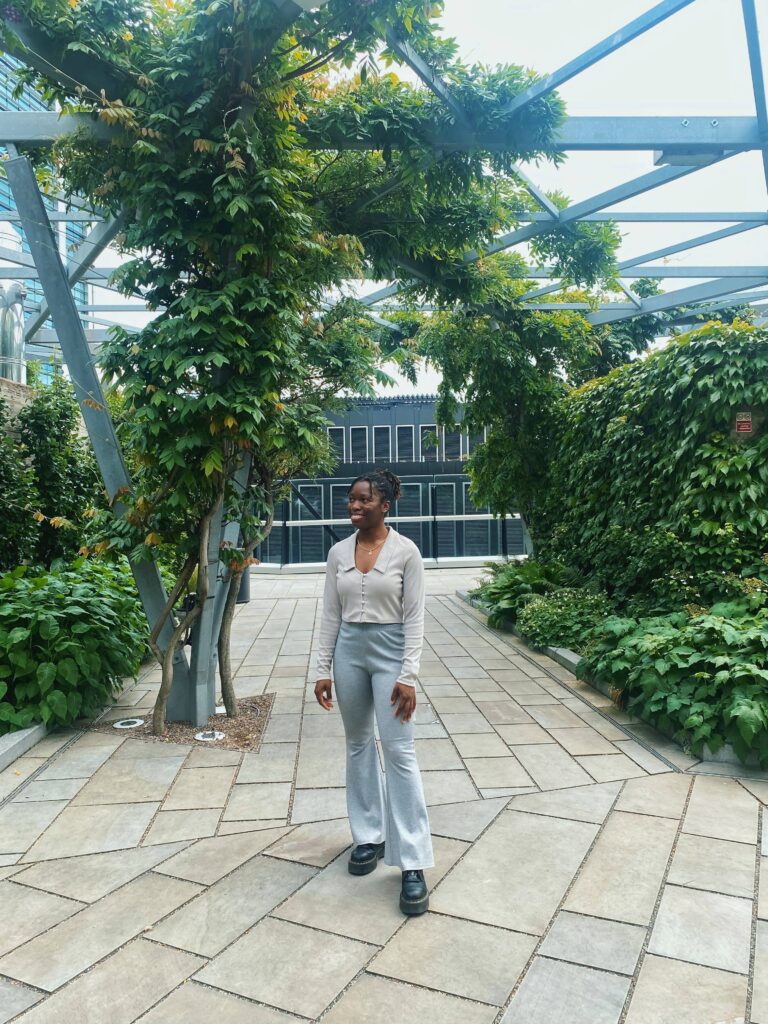 Abigail standing within the garden at Garden at 120 in London