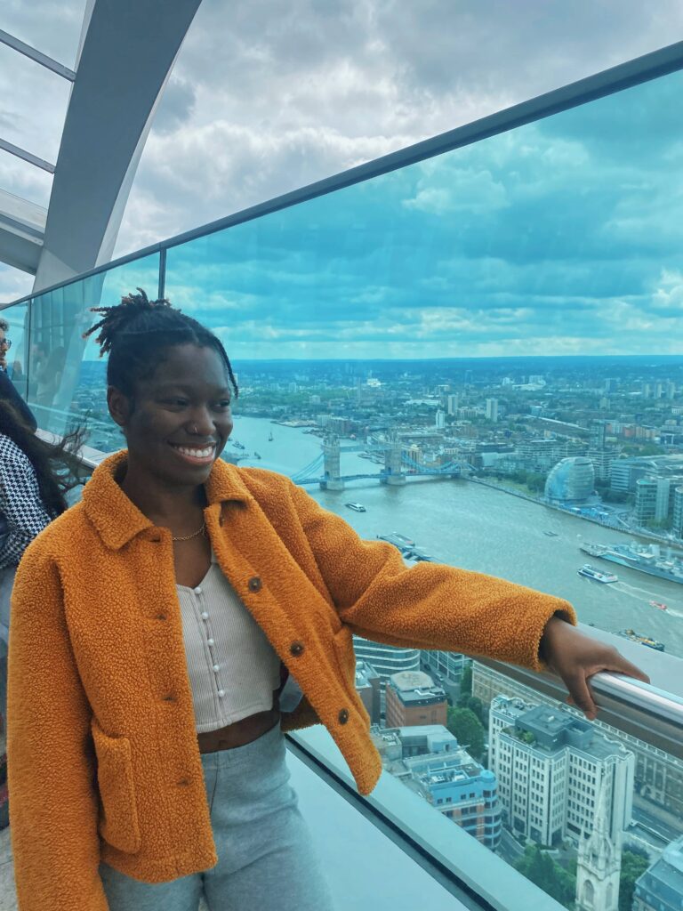 Abigail standing on the Sky Garden terrace with Tower Bridge in the background