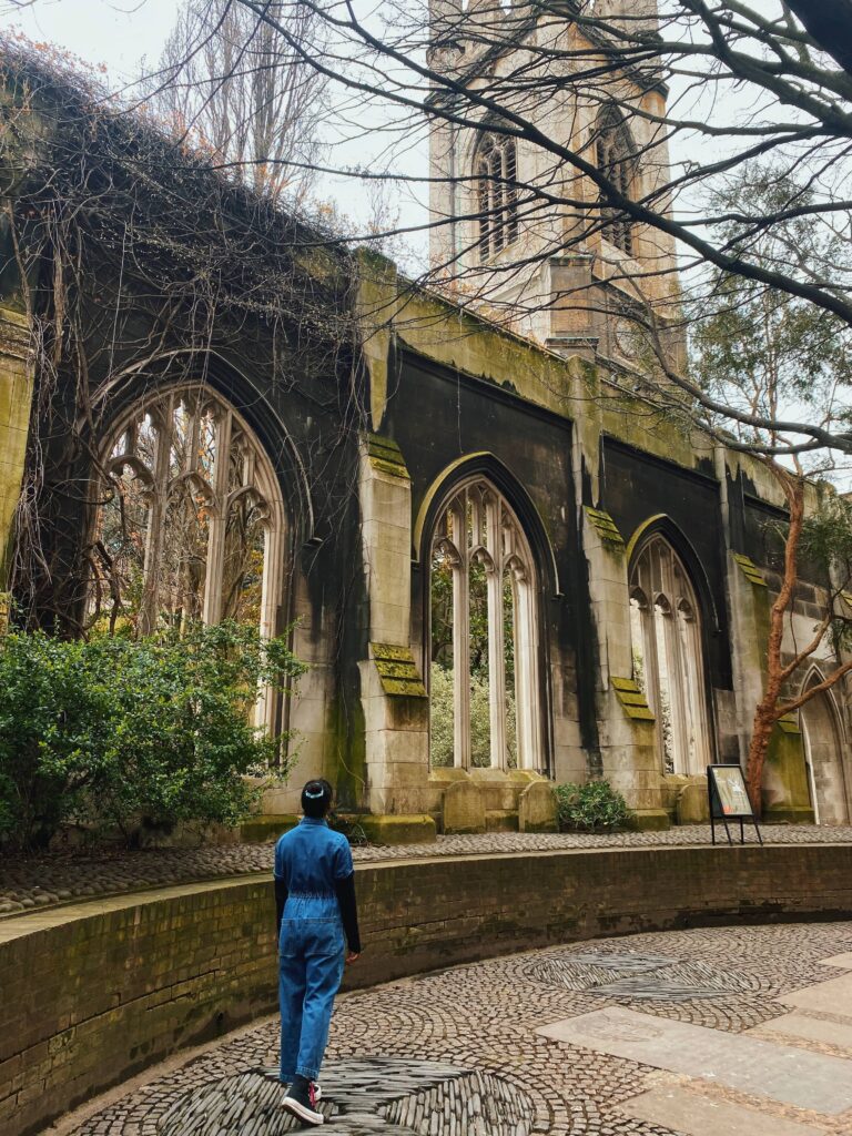 Abigail looking at the overgrown ruins of St Dunstan in the East church garden in London