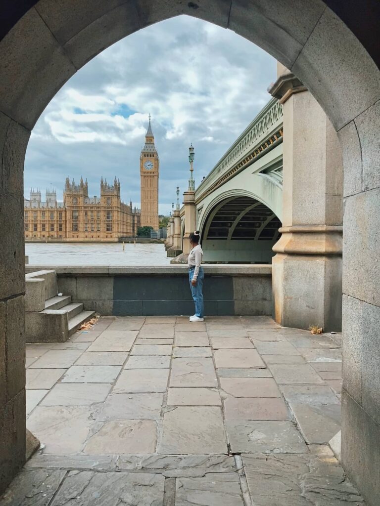 Abigail looking at Big Ben in London from under Westminster Bridge 