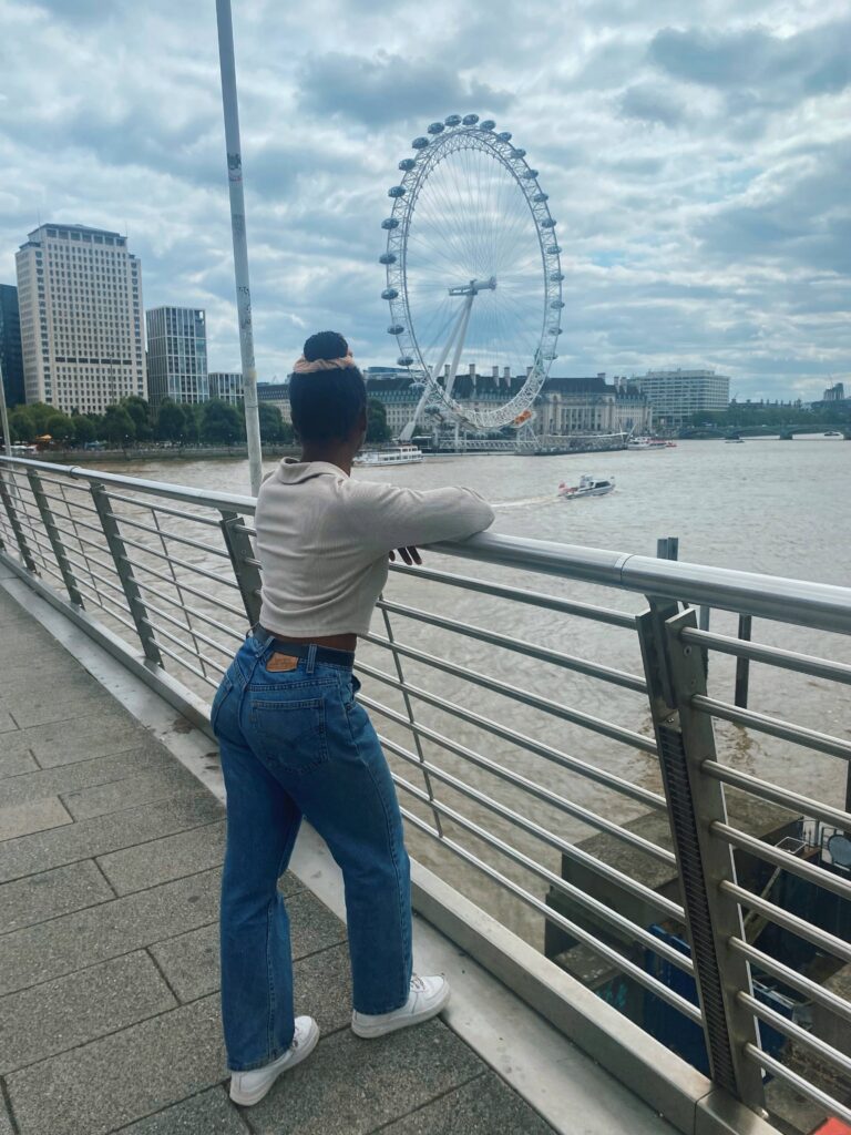 Abigail looking at the London Eye from the Golden Jubilee Bridge in London